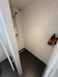 a bathroom with a shower and a toilet in it at Vakantiewoning Asteri's Home in Simpelveld +15 photos