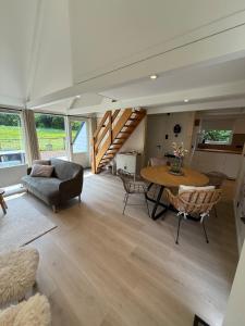 a large living room with a table and chairs at Vakantiewoning Asteri's Home in Simpelveld