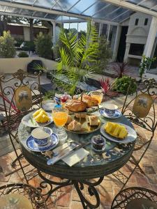 a table with plates of food on a patio at Château de Naie in Avon-les-Roches