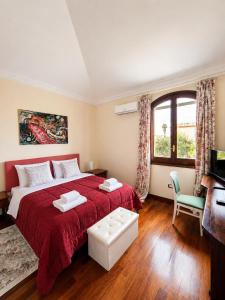 a bedroom with a large bed with a red blanket at Amunì da Vita e Pietro in Carini