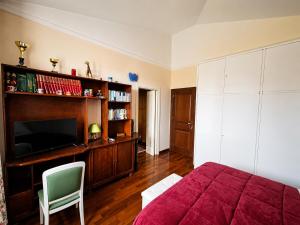 a bedroom with a bed and a flat screen tv at Amunì da Vita e Pietro in Carini +30 photos