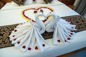 two white swansrendered to look like hearts on a bed at Soulstar Villa Ubud in Ubud +96 photos