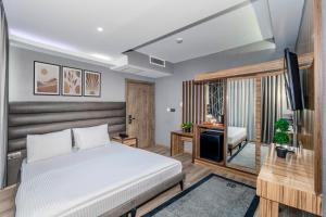 a bedroom with a bed and a flat screen tv at Dem İstanbul Airport Hotel in Istanbul +68 photos