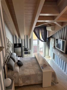 a bedroom with a bed and a tv on the wall at Storico in Como