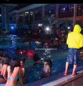 a group of people playing in a swimming pool at Paris Suites in Festac Town