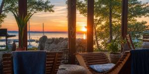 a restaurant with a view of the ocean at sunset at The Riva Sun-Suite in Šamorín