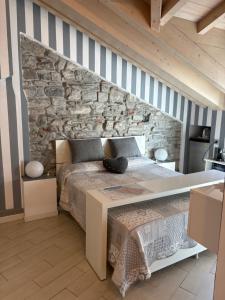 a bedroom with a bed and a stone wall at Storico in Como