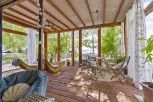 a screened in porch with chairs and a table at The Riva Sun-Suite in Šamorín