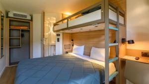 a bedroom with a bunk bed in a room at Premiere Classe Versailles - Saint Cyr L'ecole in Saint-Cyr-lʼÉcole