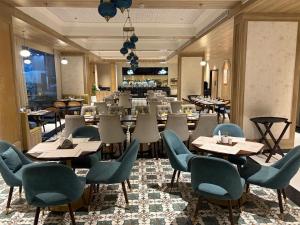 a restaurant with tables and chairs in a room at Belle Vue Stays in Jaipur