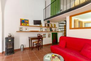 a living room with a red couch and a table at GuestHost - Casa Paola in Cannole