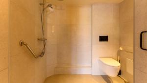 a bathroom with a toilet and a shower at Premiere Classe Versailles - Saint Cyr L'ecole in Saint-Cyr-lʼÉcole +30 photos