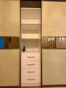 a closet with white drawers and a mirror at the HAPPY PLACE in Mykolaiv