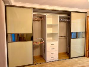 a walk in closet with sliding glass doors at the HAPPY PLACE in Mykolaiv +38 photos