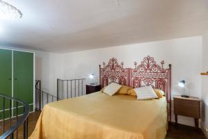 a bedroom with a large bed with a red headboard at GuestHost - Casa Paola in Cannole