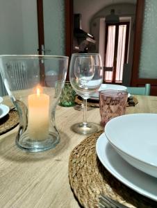 a table with a candle and two wine glasses at A Casa di Laura in Sulmona +27 photos