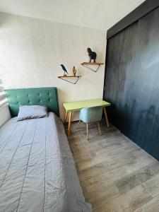 a bedroom with a bed and a desk and a table at Camino antiguo a Tesistan in Zapopan