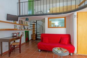 a living room with a red couch and a table at GuestHost - Casa Paola in Cannole