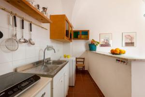 a kitchen with a sink and a counter at GuestHost - Casa Paola in Cannole +12 photos
