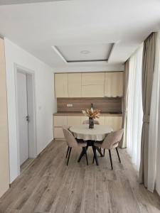 a dining room with a table and chairs at Luxury Studio Apartment with Sea View & Heated Pool in Kotor