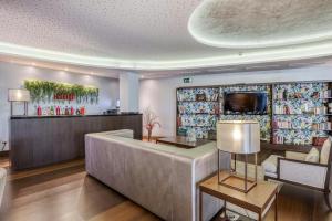 a lobby of a hotel with a bar at Sercotel Coliseo in Bilbao