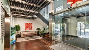a lobby of a building with a couch and a window at Sercotel Coliseo in Bilbao