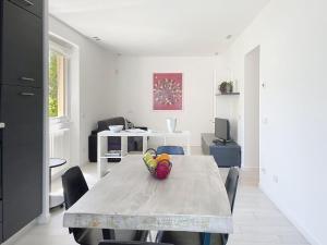 a kitchen and dining room with a table and chairs at Apartment Titti - GLA133 by Interhome in Gera Lario