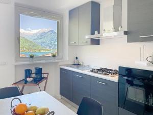 a kitchen with a window and a table with fruit at Apartment Titti - GLA133 by Interhome in Gera Lario