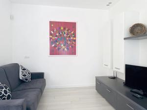 a living room with a couch and a painting on the wall at Apartment Titti - GLA133 by Interhome in Gera Lario