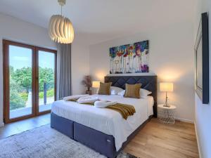 a bedroom with a large bed and a large window at Holiday Home Sara by Interhome in Tar