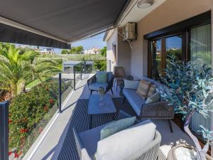a balcony with couches and chairs on a patio at Holiday Home Sara by Interhome in Tar