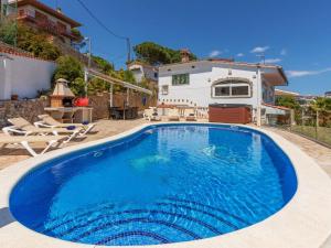 a swimming pool in front of a house at Holiday Home Floramar by Interhome in Lloret de Mar +31 photos