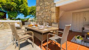 a wooden table and chairs on a patio at La Venta de Pedro in Ribadesella