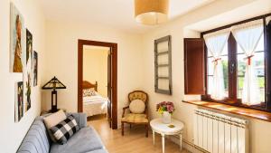 a living room with a couch and a bed at La Venta de Pedro in Ribadesella