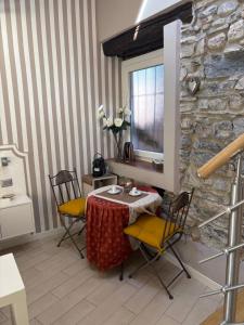 a table and chairs in a room with a stone wall at Storico in Como
