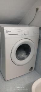 a washing machine in a bathroom with a toilet at Vico Girone in Patti
