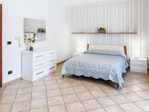 a bedroom with a bed and a white dresser at Holiday Home Collina San Ponzio by Interhome in Barolo