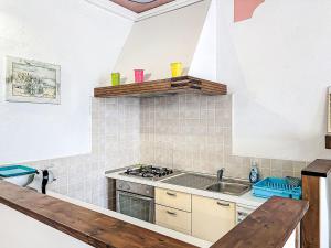 a kitchen with a sink and a stove top oven at Holiday Home Il Cavaliere by Interhome in Castellero +25 photos