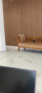 a couch with a pillow on it in a room at Aman Residency in Thodupuzha +23 photos