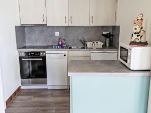 a kitchen with white cabinets and a counter top at Apartment Ritz by Interhome in Ernen