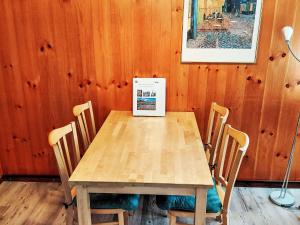 a wooden table with chairs and a box on it at Apartment Ritz by Interhome in Ernen