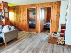a living room with wooden walls and a couch at Apartment Ritz by Interhome in Ernen
