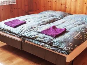 a bed with purple pillows on top of it at Apartment Ritz by Interhome in Ernen +23 photos