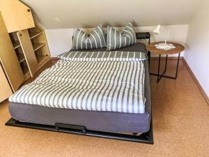 a large bed in a room with a side table at Apartment Am Wald by Interhome in Westerstede