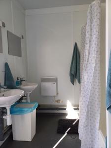 a bathroom with two sinks and a mirror at The Riva Sun-Suite in Šamorín