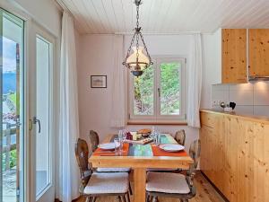 a dining room with a table and chairs and a chandelier at Apartment Chalet Holzwurm-1 by Interhome in Grindelwald +19 photos