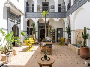 a courtyard with furniture and plants in a building at Riad Amya & Spa in Marrakesh