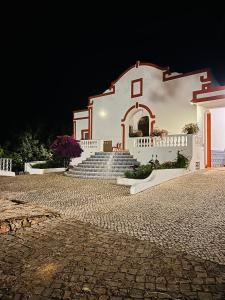 a white church with stairs in the night at Villa Madeira in Silves