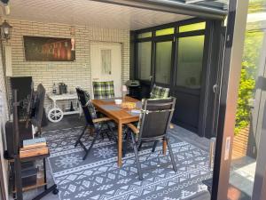 a screened in porch with a table and chairs at Ferienhaus Menkhoff in Dornumersiel