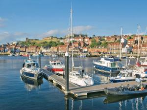 a group of boats docked at a dock in a harbor at Bosuns Rest - 16265 in Staithes +24 photos